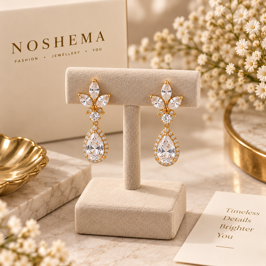 Celeste Drop Earrings by Noshema — gold floral drop earrings with sparkling pear-shaped stones